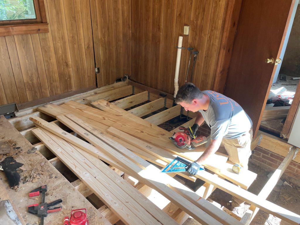 A WNC employee doing a whole flooring system replacement on a home in Western North Carolina of North Carolina.