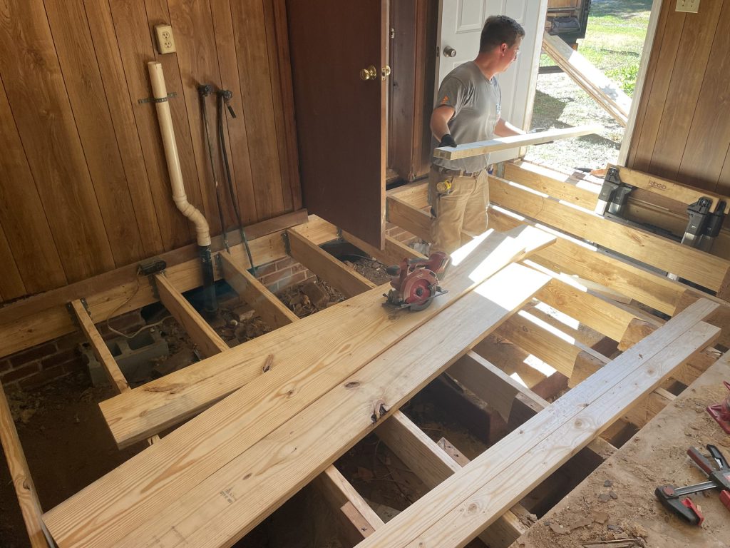 loading lumber into the room for a whole flooring system termite damage repair in Western North Carolina of North Carolina