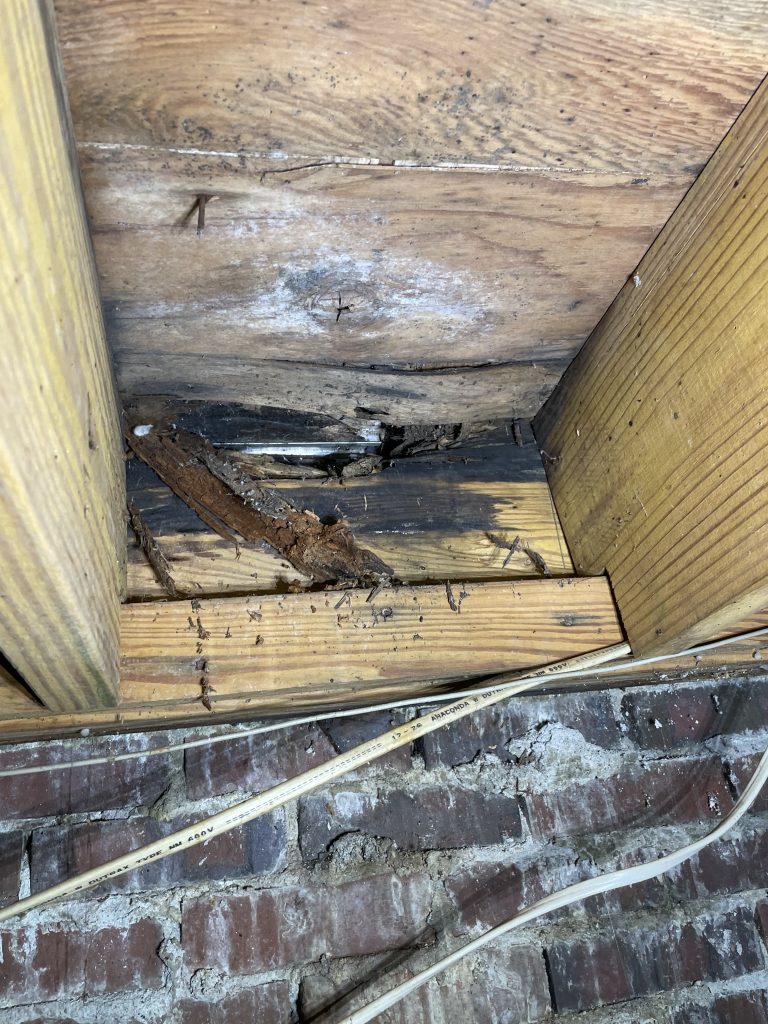 Wet rot on a band as seen from the crawlspace in the upstate of North Carolina
